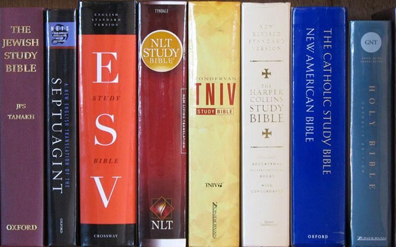 Many Bible translations on a bookcase